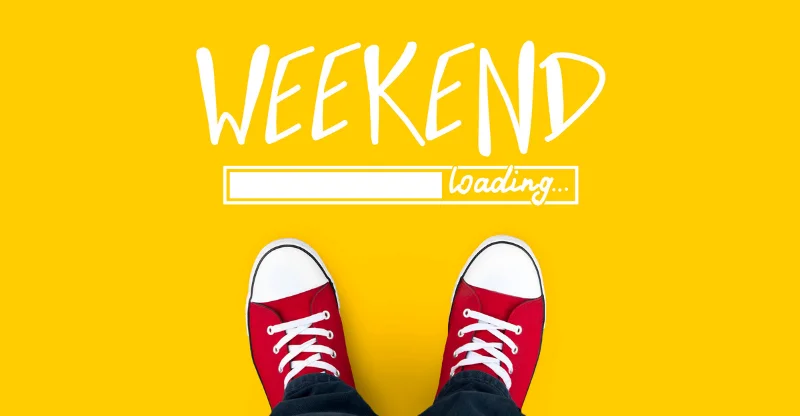 Overhead view of a person's feet in red sneakers on a vibrant yellow background. Above the shoes, the word 'WEEKEND' is written in large white letters with a progress bar below, partially filled, and the word 'loading...' indicating anticipation for the weekend