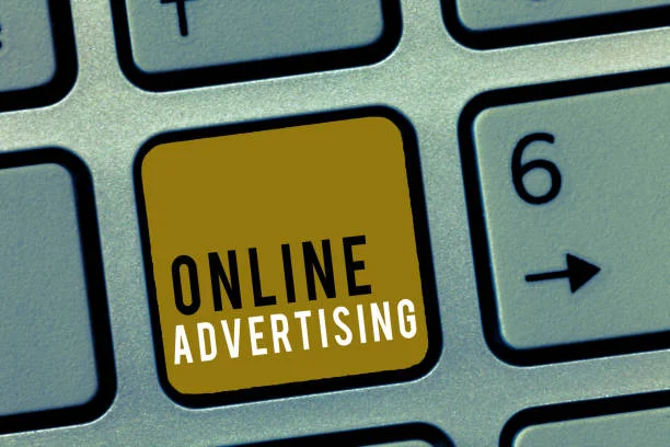 Close-up view of a computer keyboard with a distinctive yellow key labeled ‘ONLINE ADVERTISING’ among standard grey keys, highlighting the focus on digital marketing strategies.