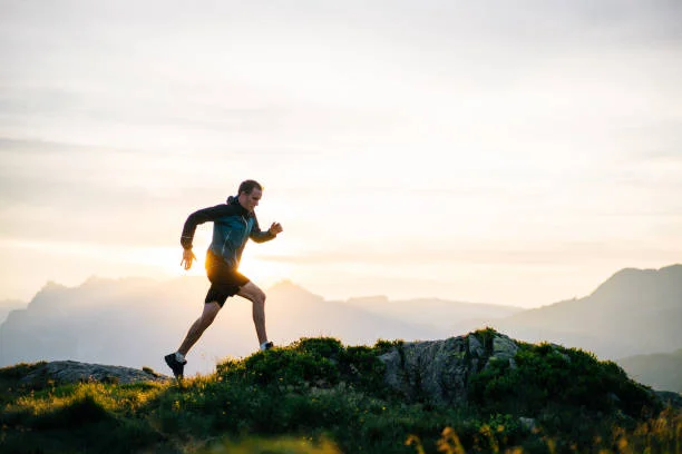 Young man runs on mountain ridge at sunrise He leaps into the morning air running on a weekend stock pictures, royalty-free photos & images