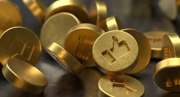 A close-up image of scattered golden coins with various symbols carved into them, such as the 'play' icon and other geometric shapes, lying on a dark surface with a blurred background. The coins glimmer with a metallic sheen, symbolizing wealth and the importance of financial literacy and money management. The image conveys the concept of unlocking financial potential and the strategic aspects of managing finances